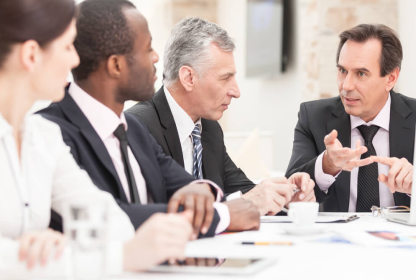 Four business humans discuss the pros of having a table